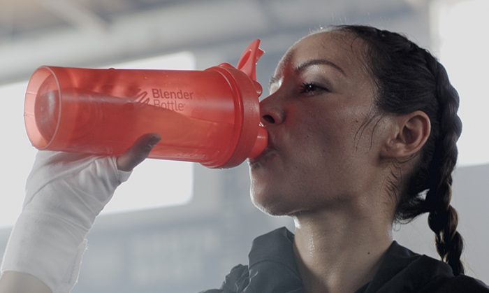 Woman drinking from a shaker bottle