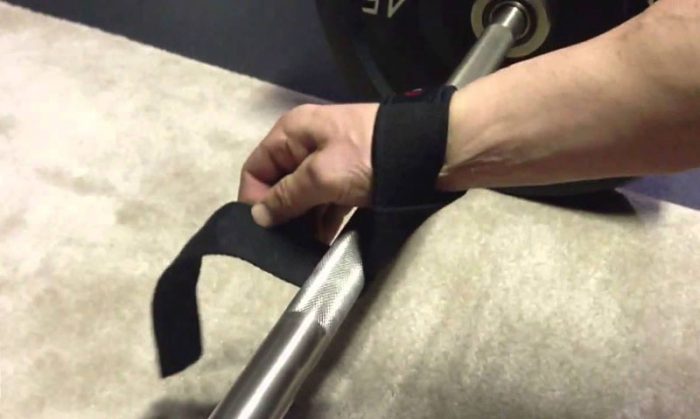 Wrapping lifting straps around barbell