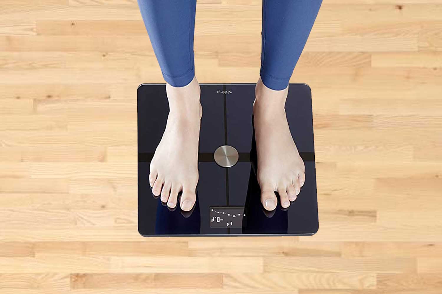Smart weighing scale on wooden floor